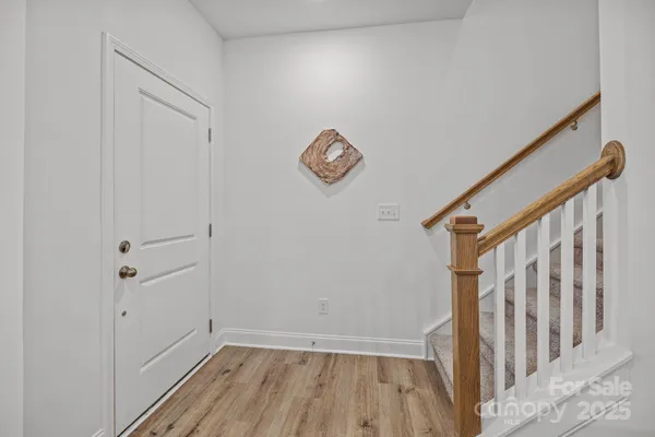 a view of entryway with stairs and wooden floor
