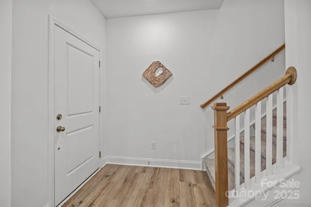 a view of entryway with stairs and wooden floor