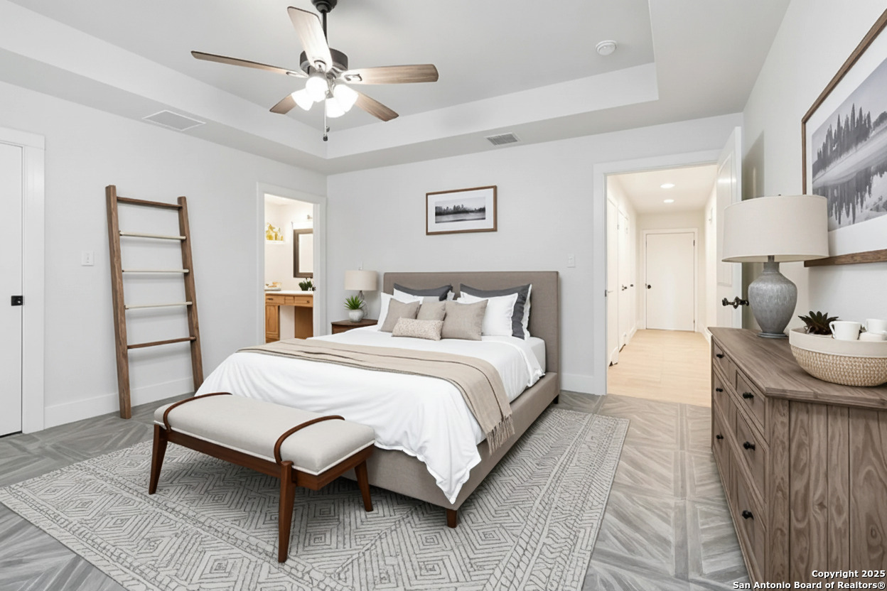 188 Old Camp Road Bandera, TX 78003 - Photo 13 of 36 a bedroom with a bed and a chandelier