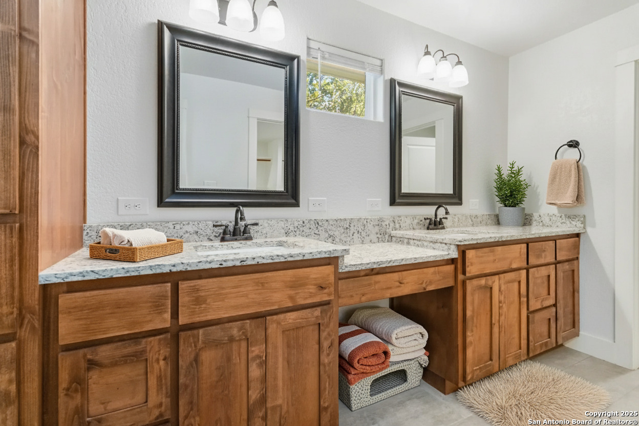 188 Old Camp Road Bandera, TX 78003 - Photo 14 of 36 a bathroom with a sink vanity and mirror