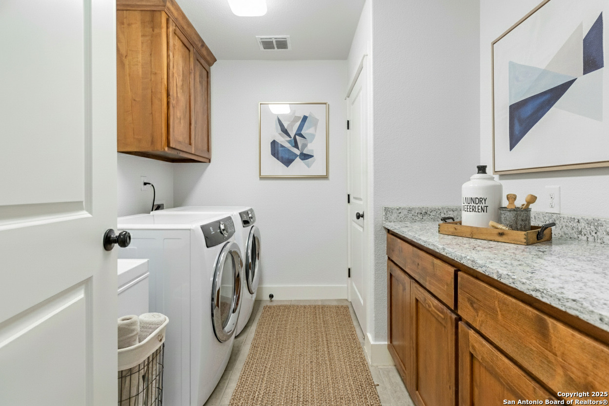 188 Old Camp Road Bandera, TX 78003 - Photo 21 of 36 a utility room with a sink a washer and dryer