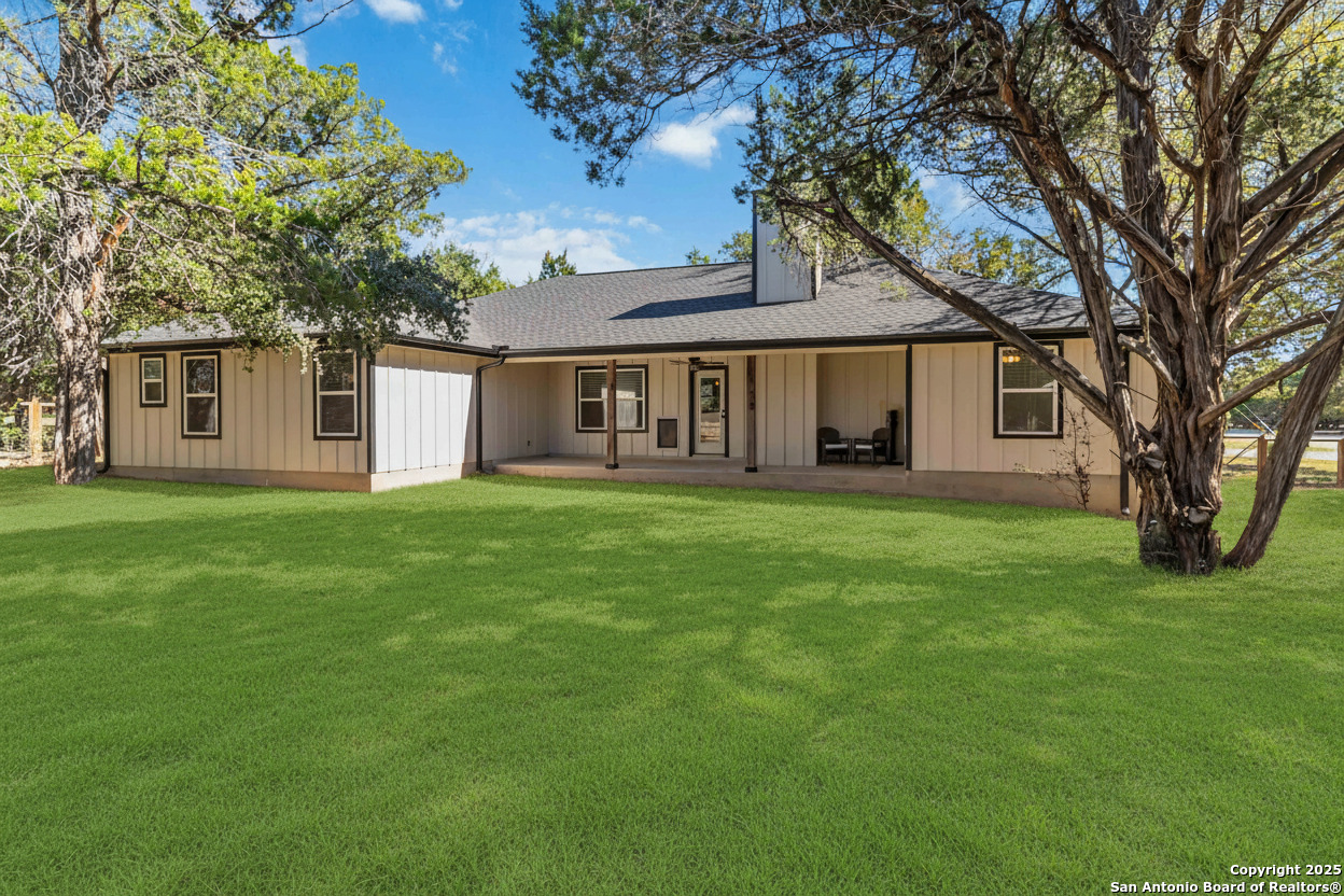 188 Old Camp Road Bandera, TX 78003 - Photo 22 of 36 a front view of house with yard and green space