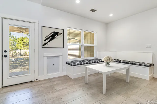 a dining room with furniture and window