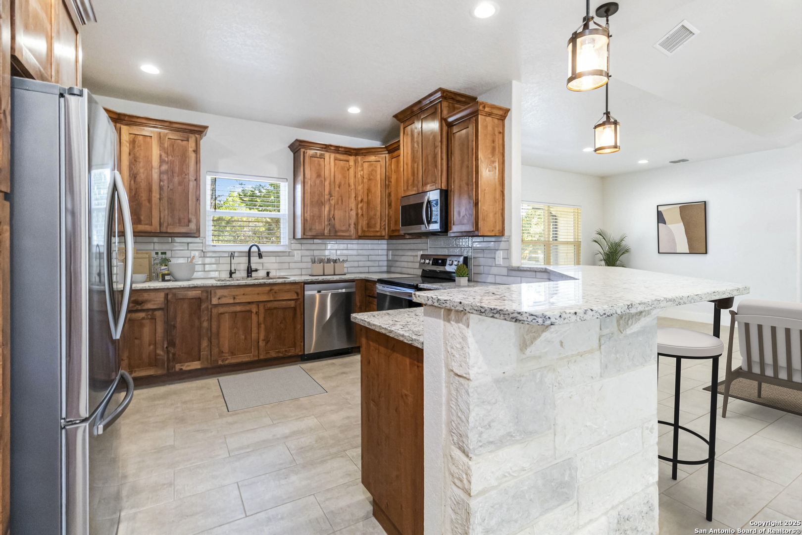 188 Old Camp Road Bandera, TX 78003 - Photo 7 of 36 a kitchen with a sink window and cabinets