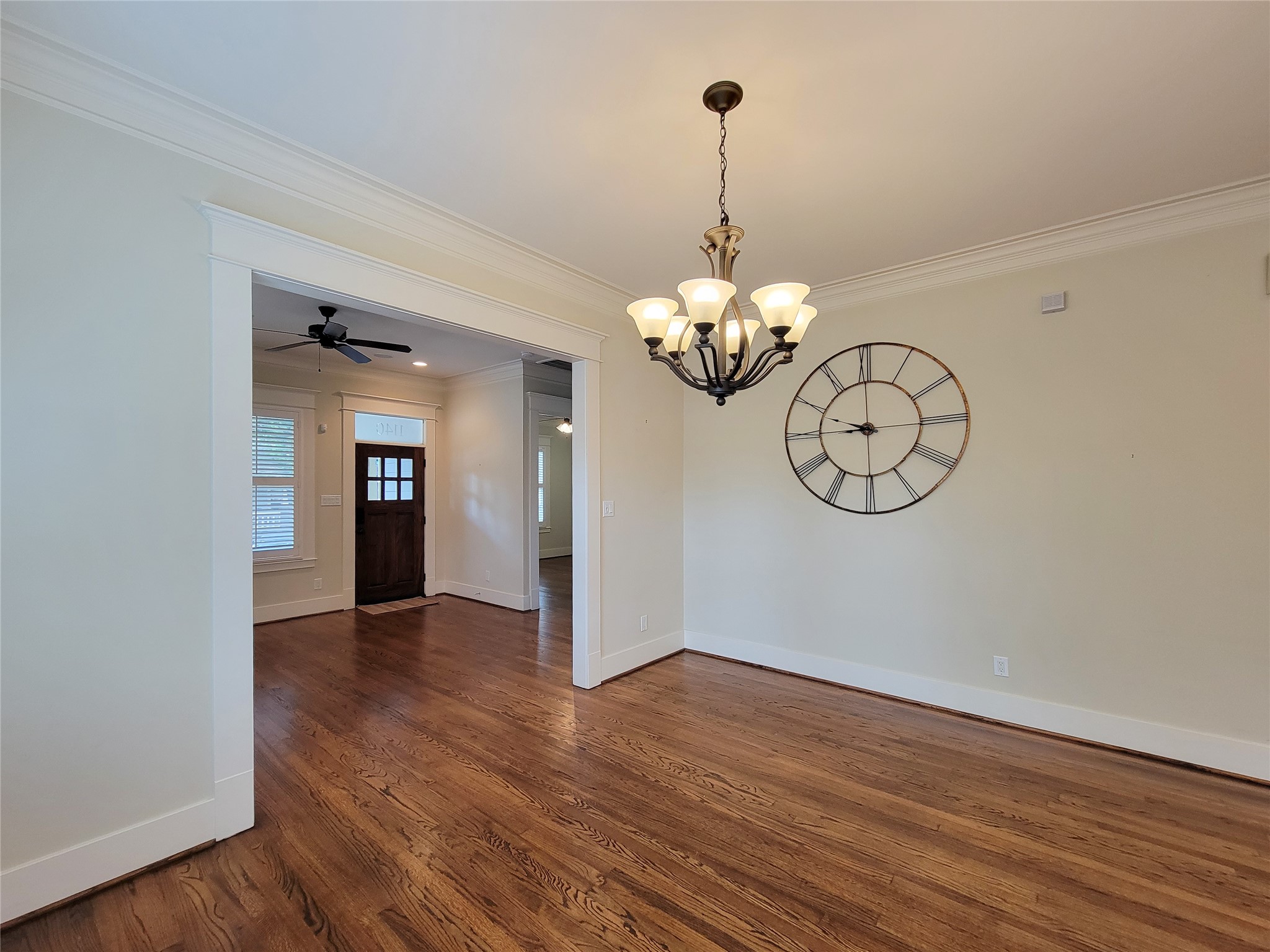 1140 West Cottage Street Houston, TX 77009 - Photo 20 of 37 a view of a hallway with wooden floor and chandelier