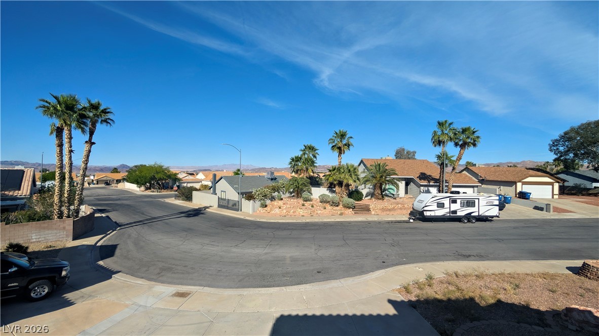 104 Appian Way Henderson, NV 89002 - Photo 12 of 37 View of asphalt road featuring a residential view, sidewalks, street lighting, and curbs
