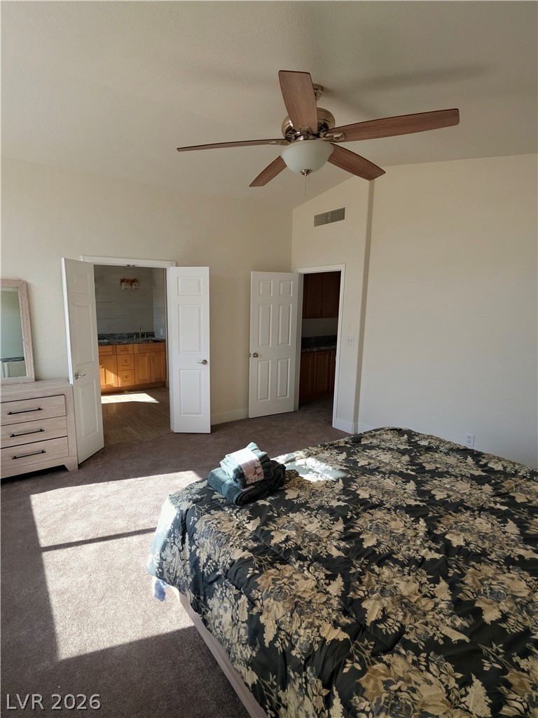 104 Appian Way Henderson, NV 89002 - Photo 13 of 37 Bedroom with lofted ceiling, dark carpet, and ceiling fan