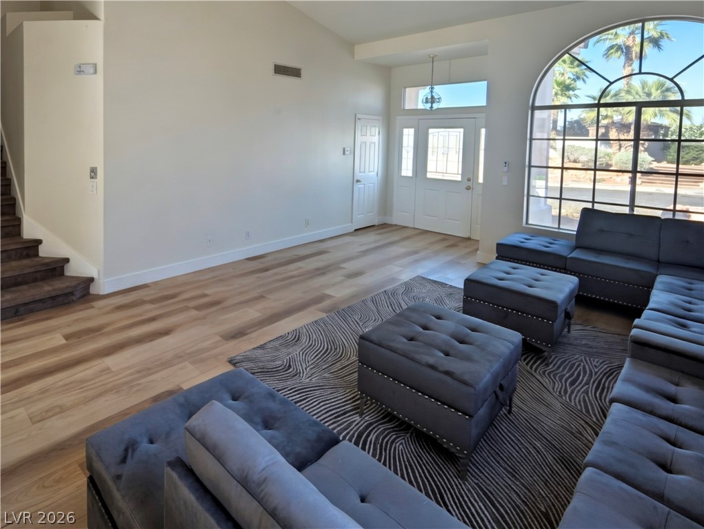 104 Appian Way Henderson, NV 89002 - Photo 17 of 37 Living room with light wood-type flooring and vaulted ceiling