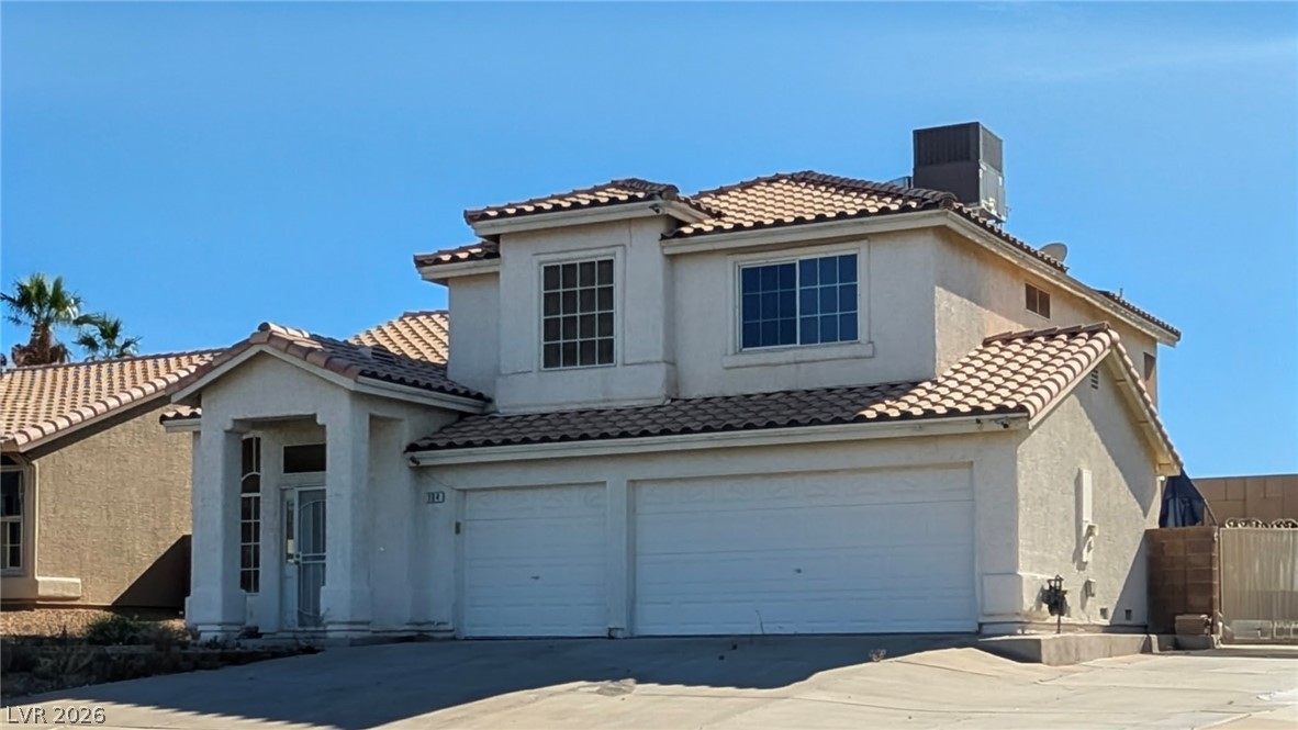 104 Appian Way Henderson, NV 89002 - Photo 2 of 37 Mediterranean / spanish house with an attached garage, a chimney, concrete driveway, stucco siding, and a tile roof