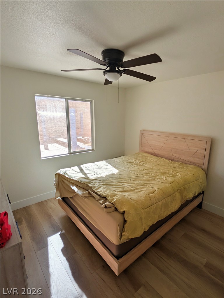 104 Appian Way Henderson, NV 89002 - Photo 29 of 37 Bedroom with dark wood-type flooring, ceiling fan, and a textured ceiling