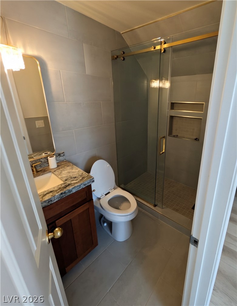 104 Appian Way Henderson, NV 89002 - Photo 35 of 37 Full bath featuring vanity, a stall shower, and tile walls