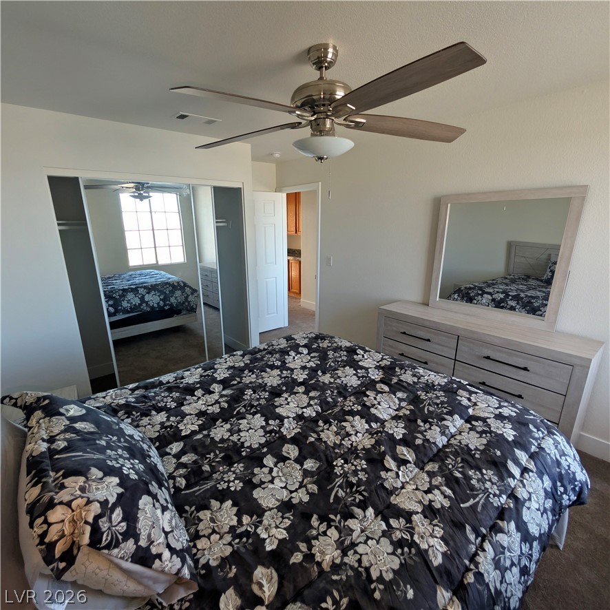 104 Appian Way Henderson, NV 89002 - Photo 7 of 37 Bedroom with dark carpet, a ceiling fan, and a closet