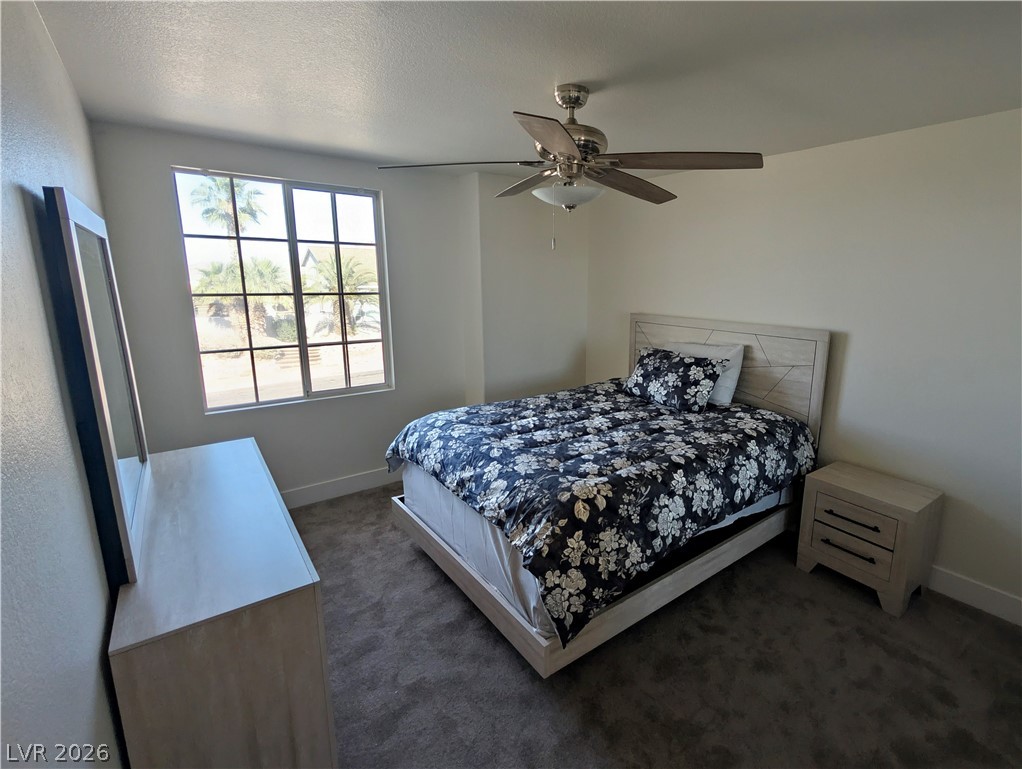 104 Appian Way Henderson, NV 89002 - Photo 8 of 37 Bedroom featuring a ceiling fan and dark carpet