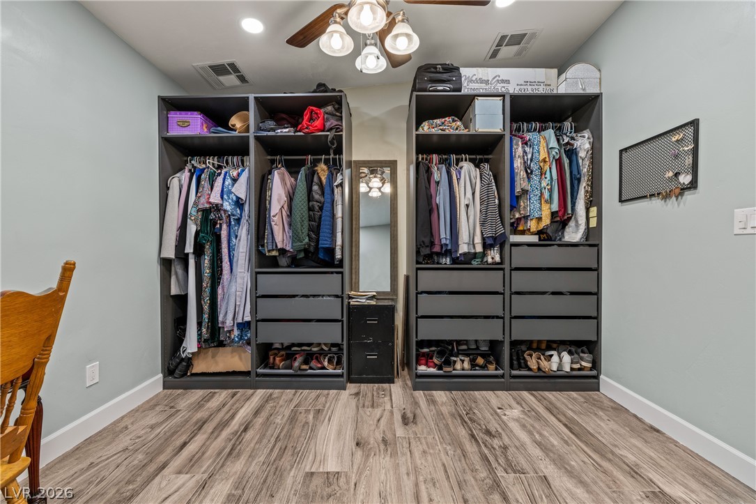750 Leming Avenue Overton, NV 89040 - Photo 40 of 82 This spacious dressing area features custom closet systems and elegant wood flooring, providing ample storage.