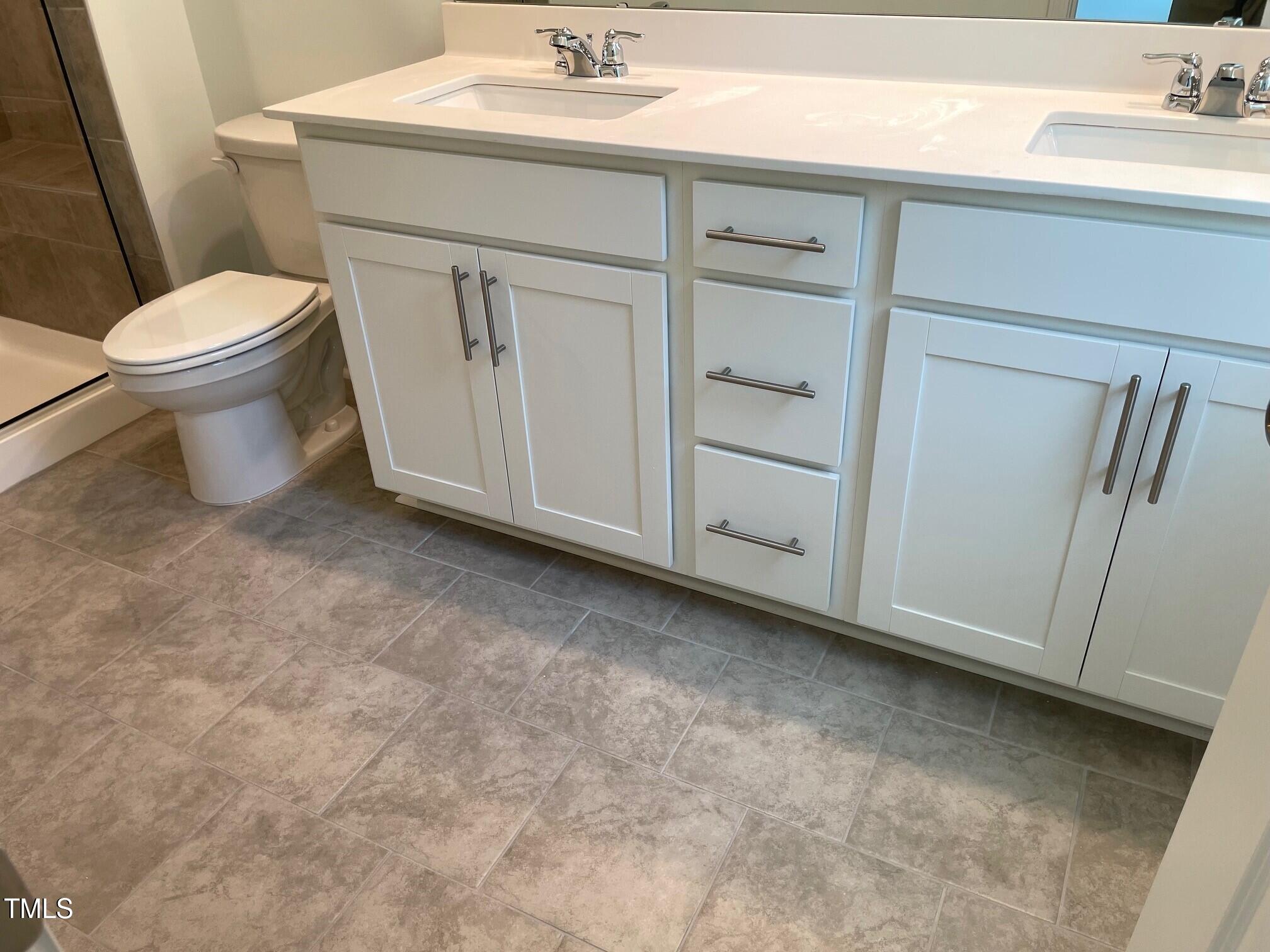 3019 Vitner Drive Durham, NC 27704 - Photo 14 of 20 a bathroom with a sink a toilet and vanity