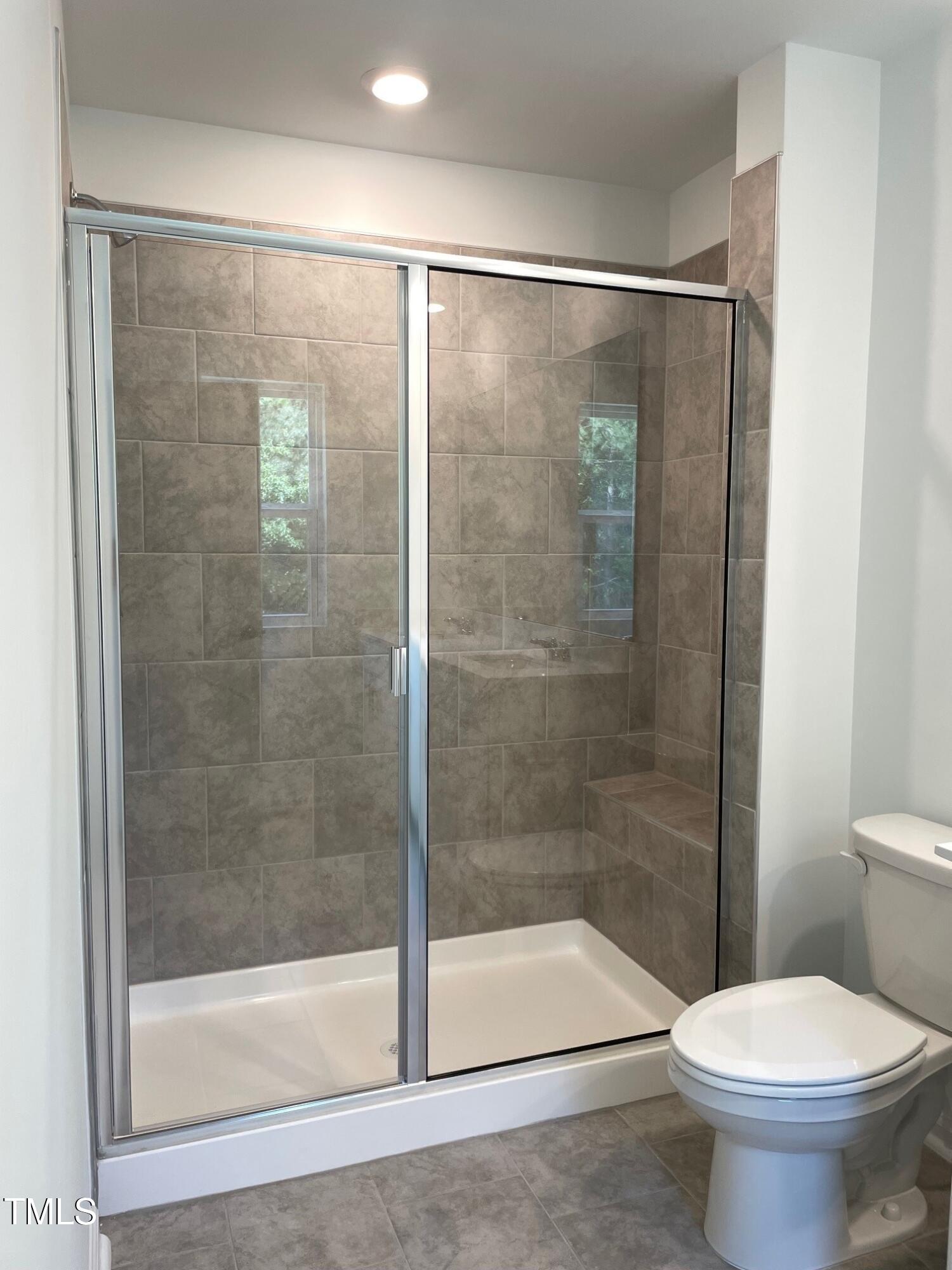 3019 Vitner Drive Durham, NC 27704 - Photo 15 of 20 a bathroom with a shower a toilet and a sink