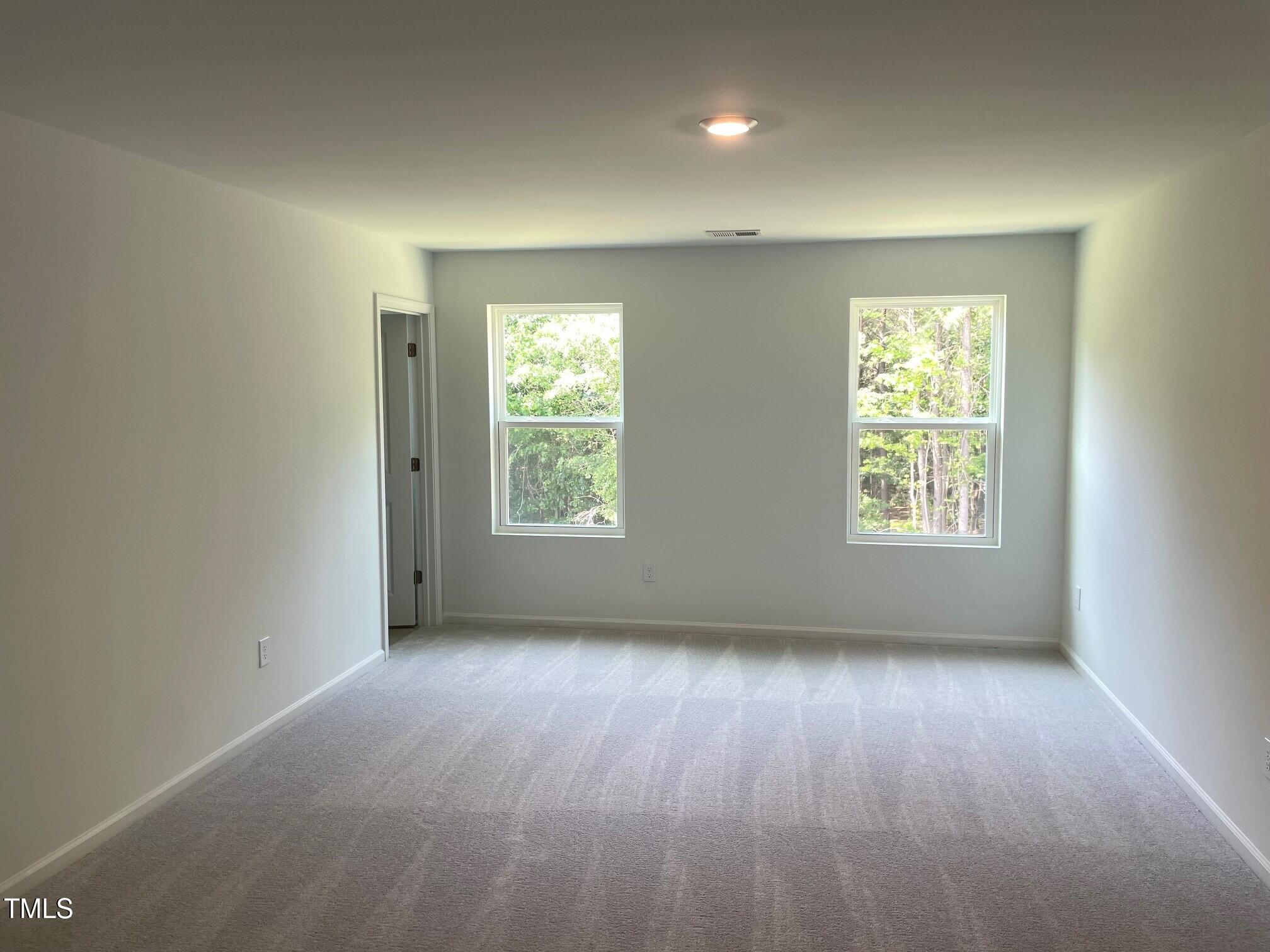 3019 Vitner Drive Durham, NC 27704 - Photo 16 of 20 an empty room with wooden floor and windows