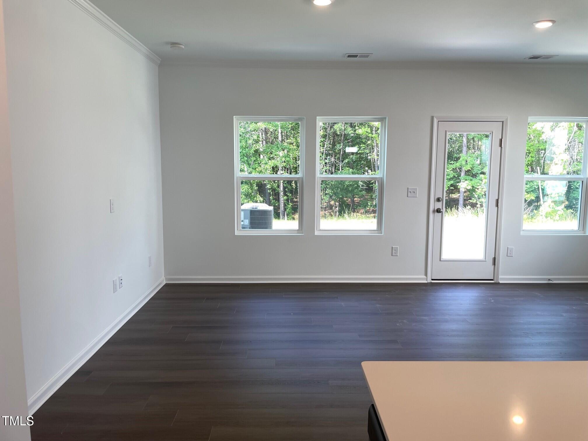 3019 Vitner Drive Durham, NC 27704 - Photo 5 of 20 an empty room with wooden floor and windows