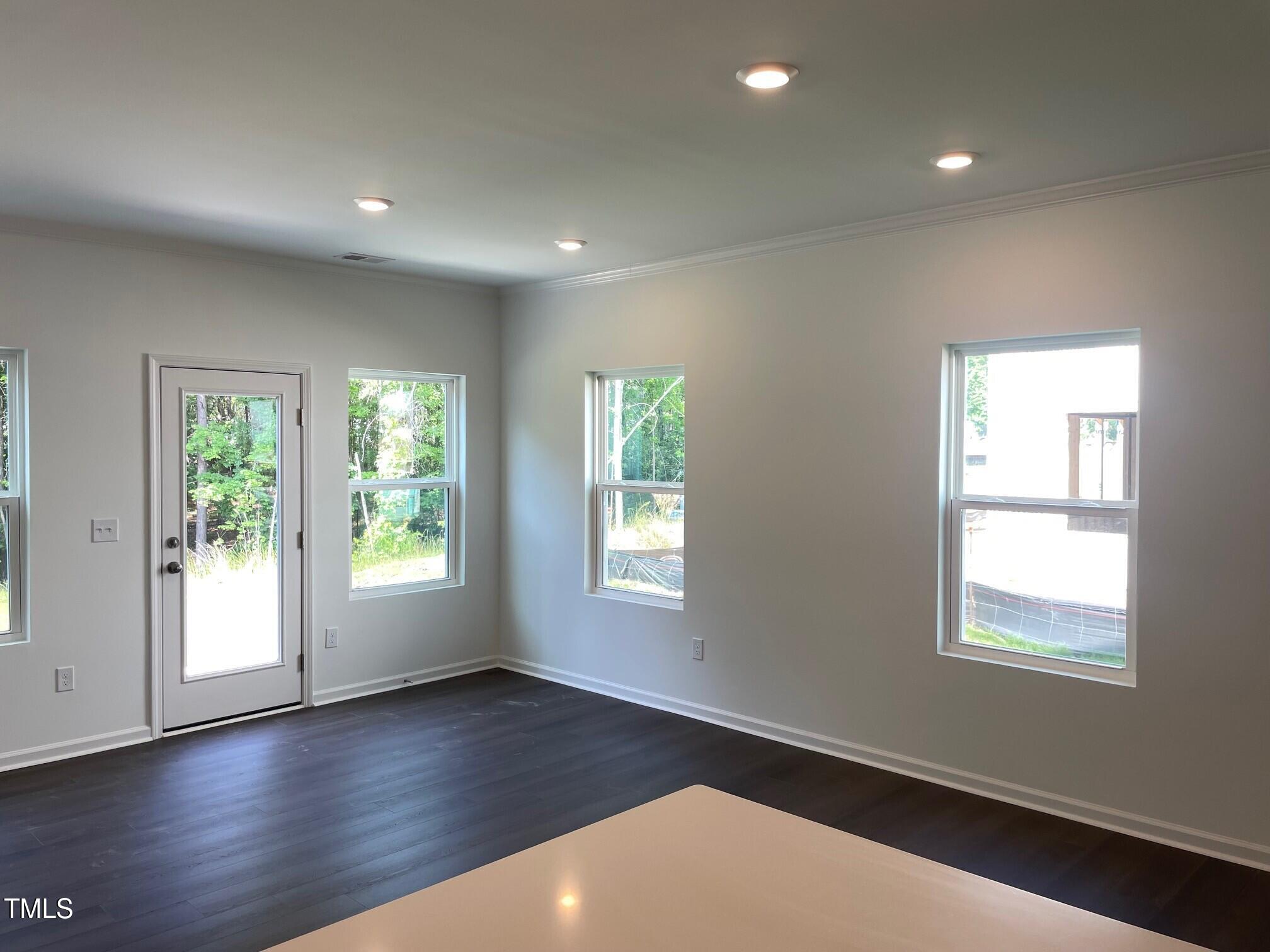 3019 Vitner Drive Durham, NC 27704 - Photo 6 of 20 an empty room with wooden floor and windows