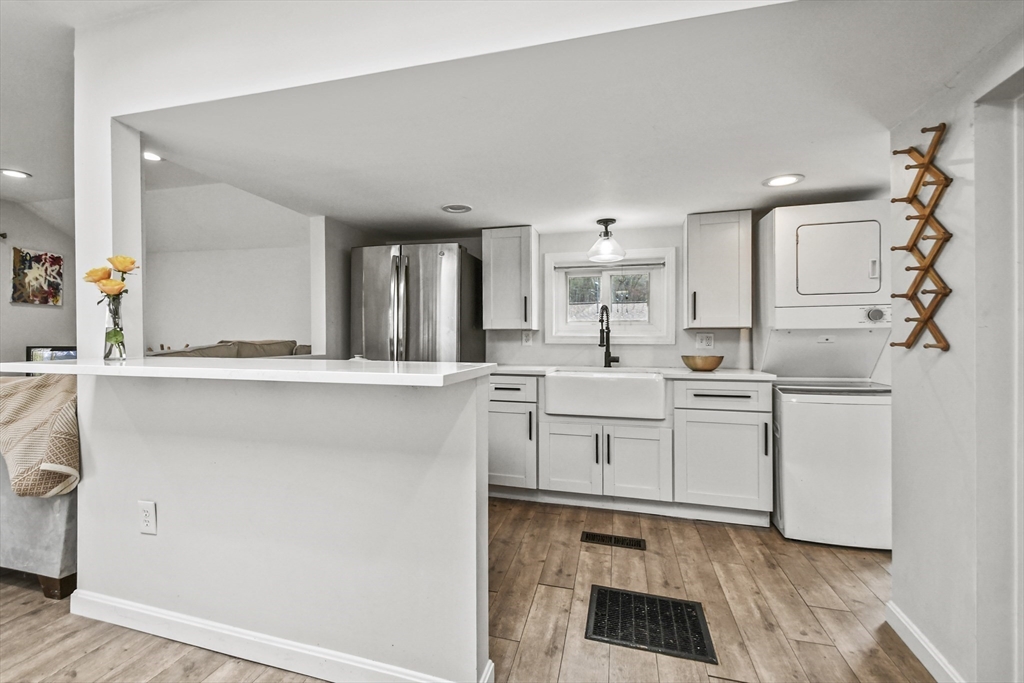 8 Hitty Road Salem, NH 03079 - Photo 11 of 26 a kitchen with granite countertop white cabinets and white appliances