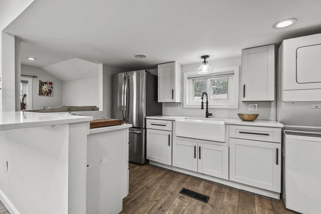 8 Hitty Road Salem, NH 03079 - Photo 12 of 26 a kitchen with white cabinets and sink