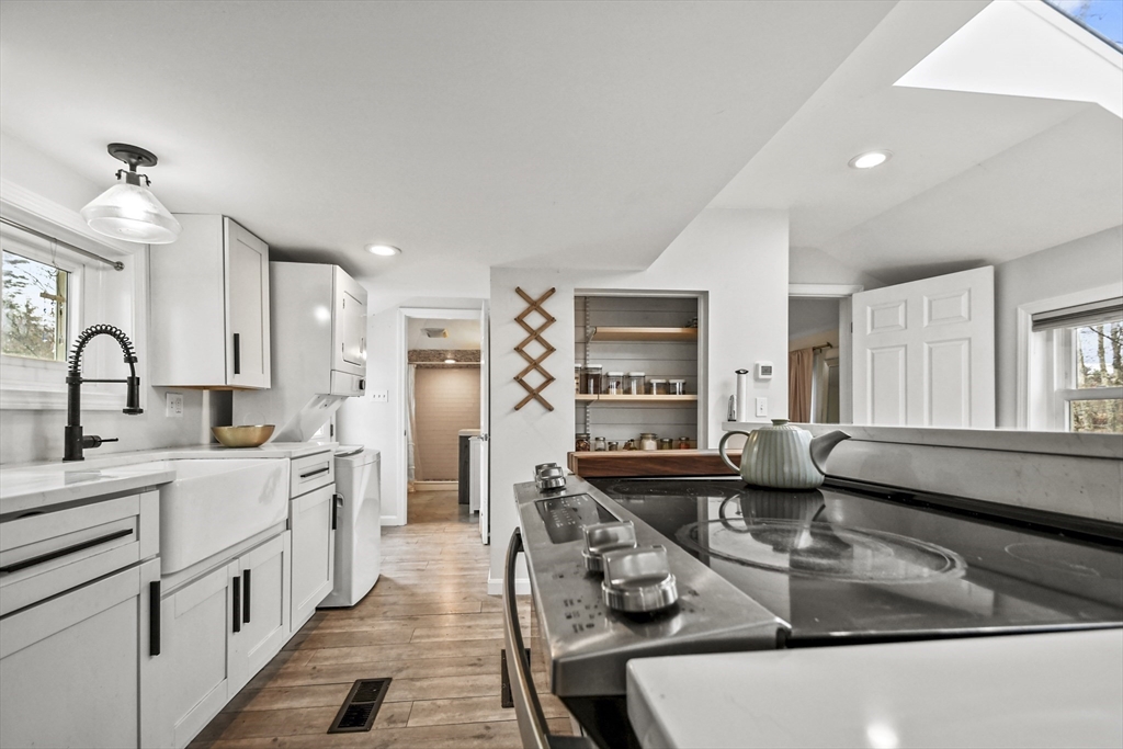 8 Hitty Road Salem, NH 03079 - Photo 13 of 26 a kitchen with stainless steel appliances granite countertop a sink stove and cabinets