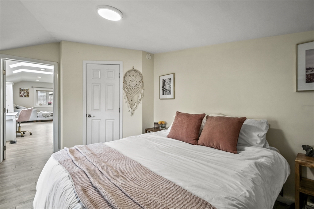 8 Hitty Road Salem, NH 03079 - Photo 17 of 26 a bedroom with a large bed and a chandelier