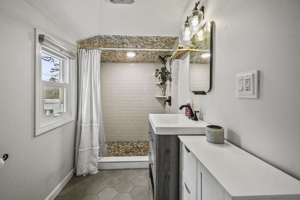 8 Hitty Road Salem, NH 03079 - Photo 18 of 26 a bathroom with a sink a toilet and shower