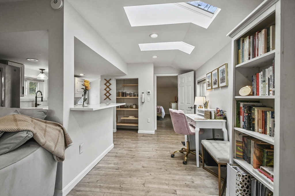 8 Hitty Road Salem, NH 03079 - Photo 8 of 26 a living room with furniture and a book shelf