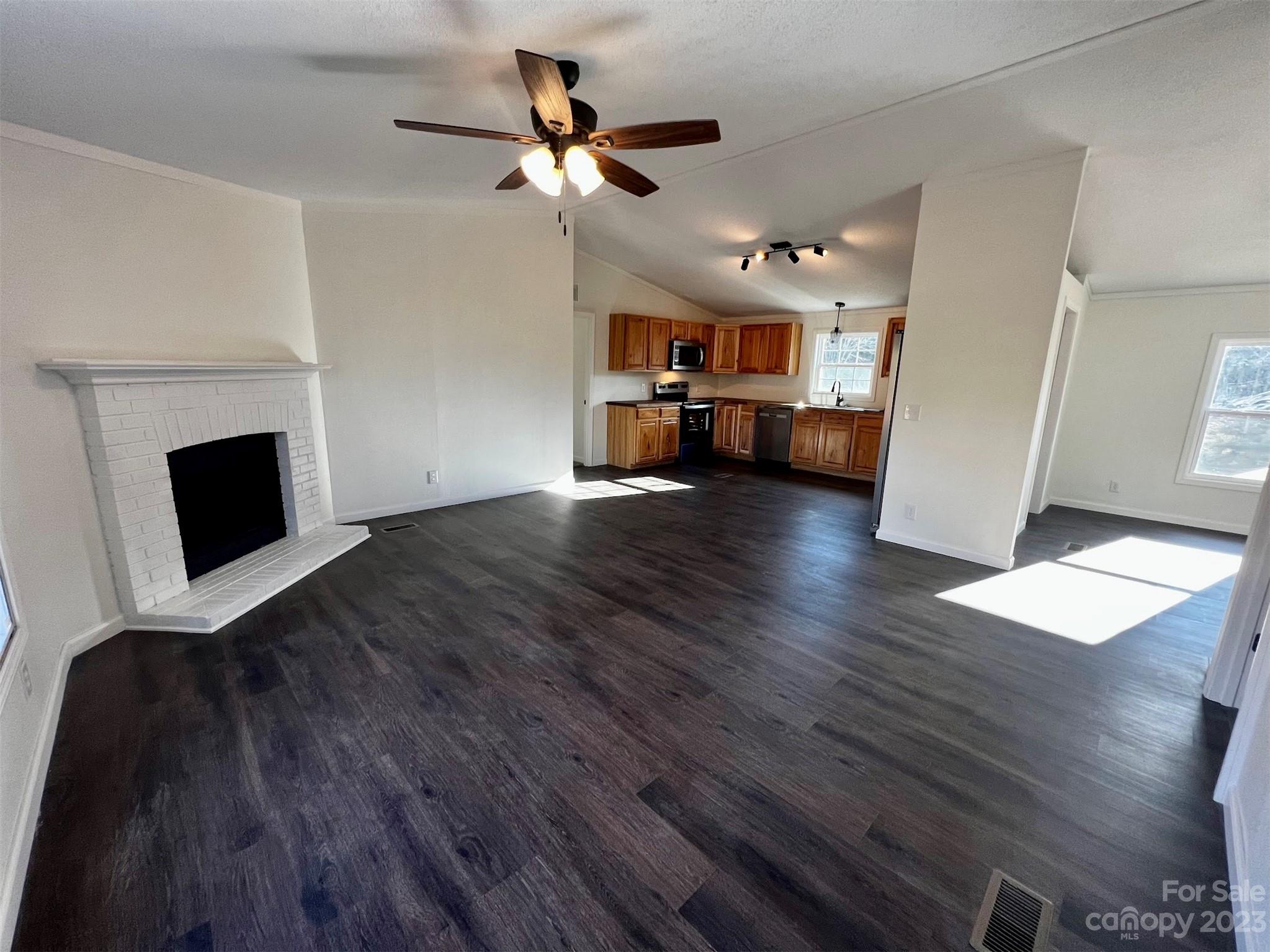 570 Scottdale Road Canton, NC 28716 - Photo 11 of 44 a view of a livingroom with wooden floor and a ceiling fan