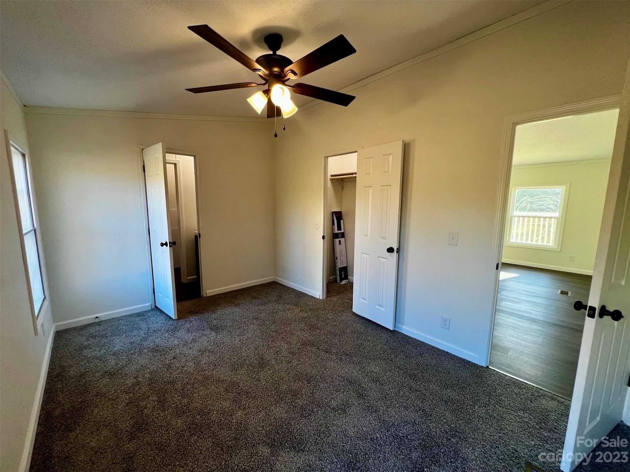 570 Scottdale Road Canton, NC 28716 - Photo 24 of 44 an empty room with closet and a chandelier fan