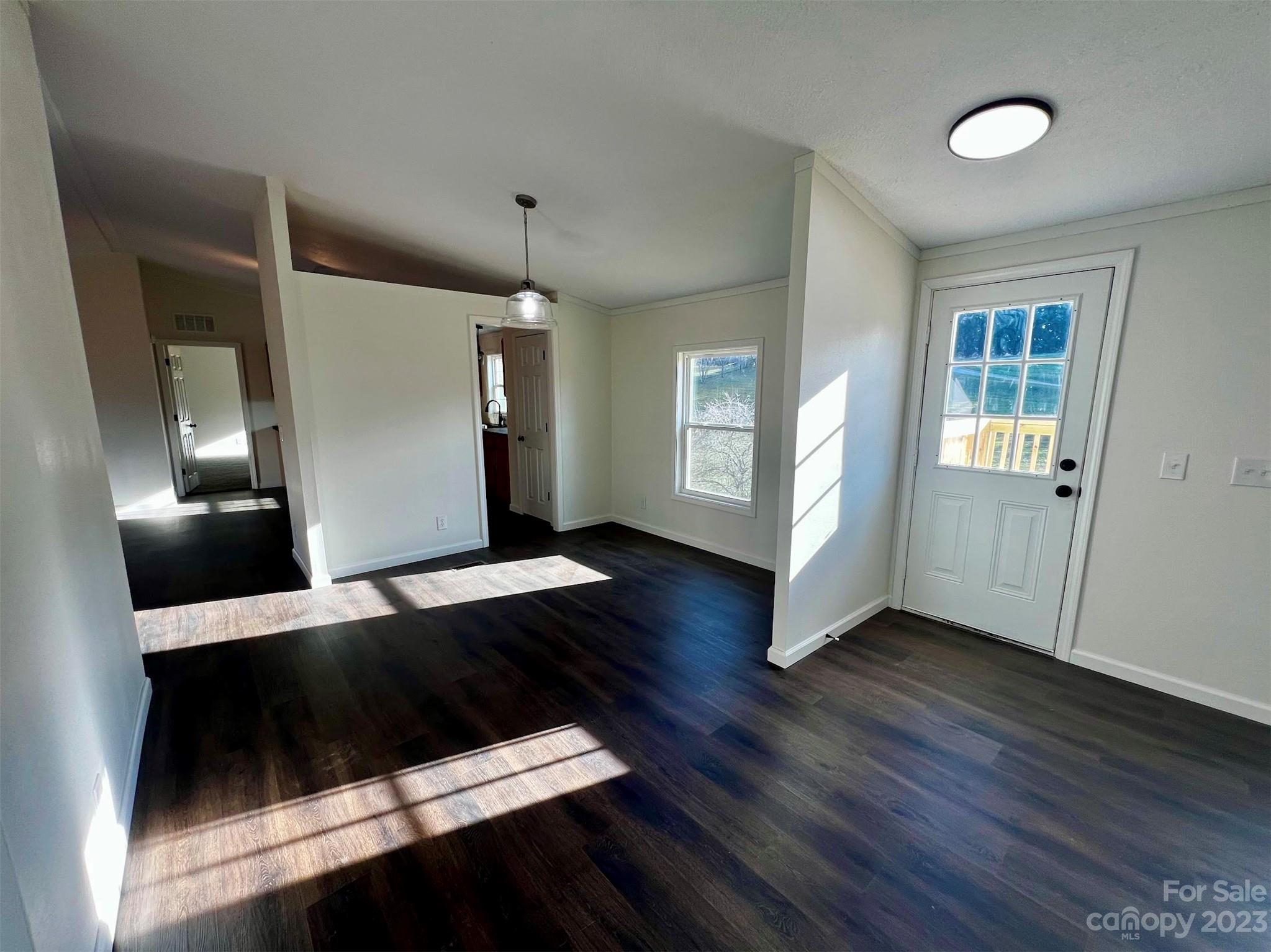 570 Scottdale Road Canton, NC 28716 - Photo 6 of 44 a view of an empty room with wooden floor and a window