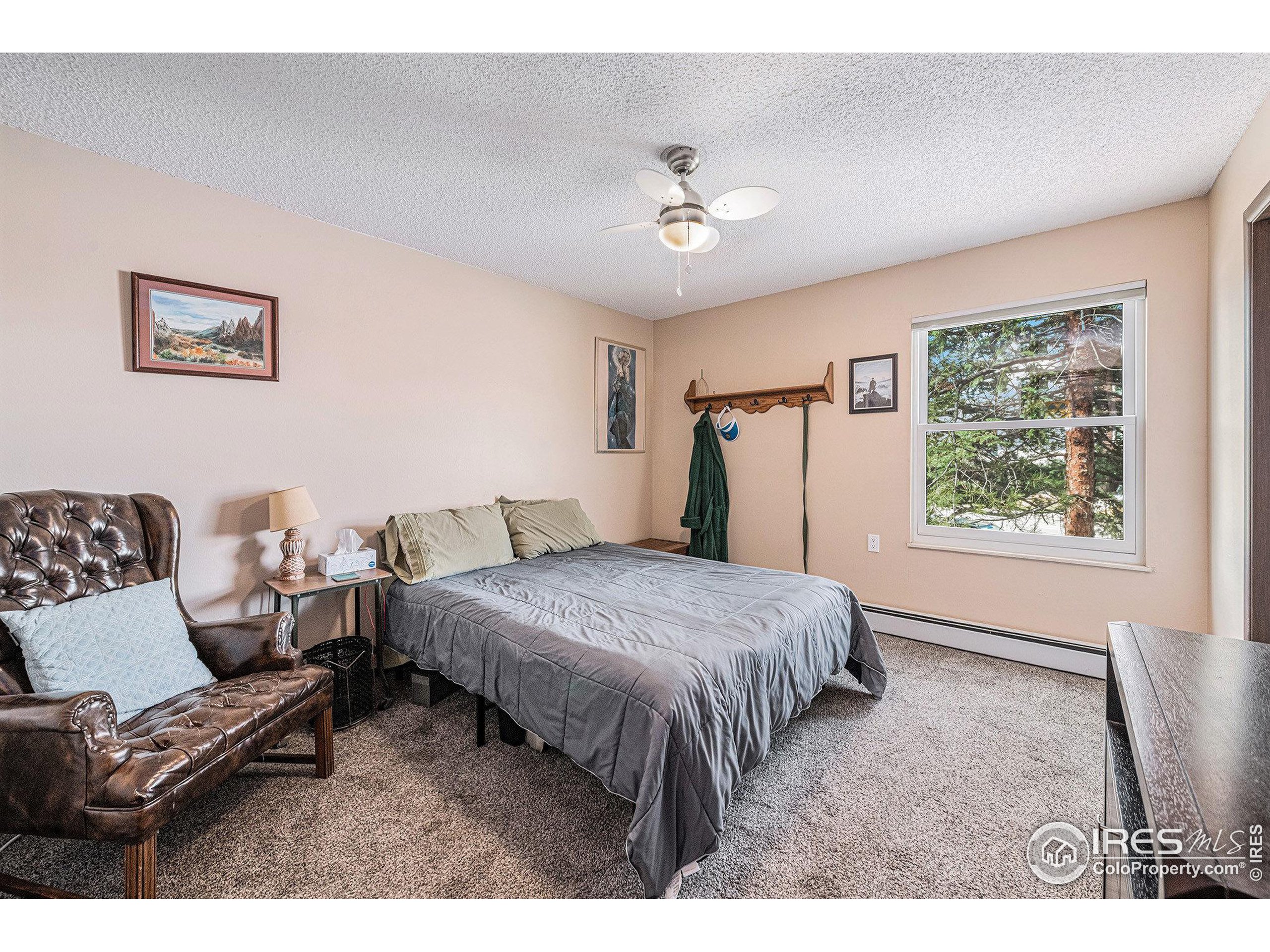 3400 Stanford Road, Unit A120 Fort Collins, CO 80525 - Photo 11 of 16 a spacious bedroom with a bed a couch and a window