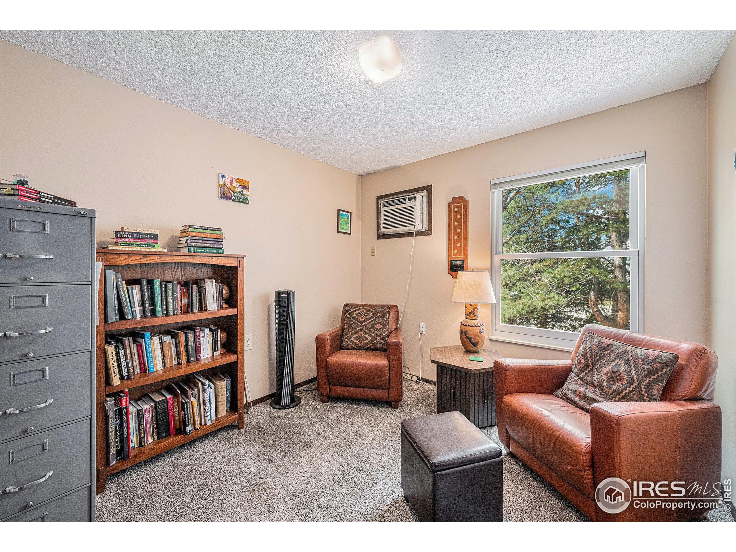 3400 Stanford Road, Unit A120 Fort Collins, CO 80525 - Photo 6 of 16 a living room with furniture and a book shelf