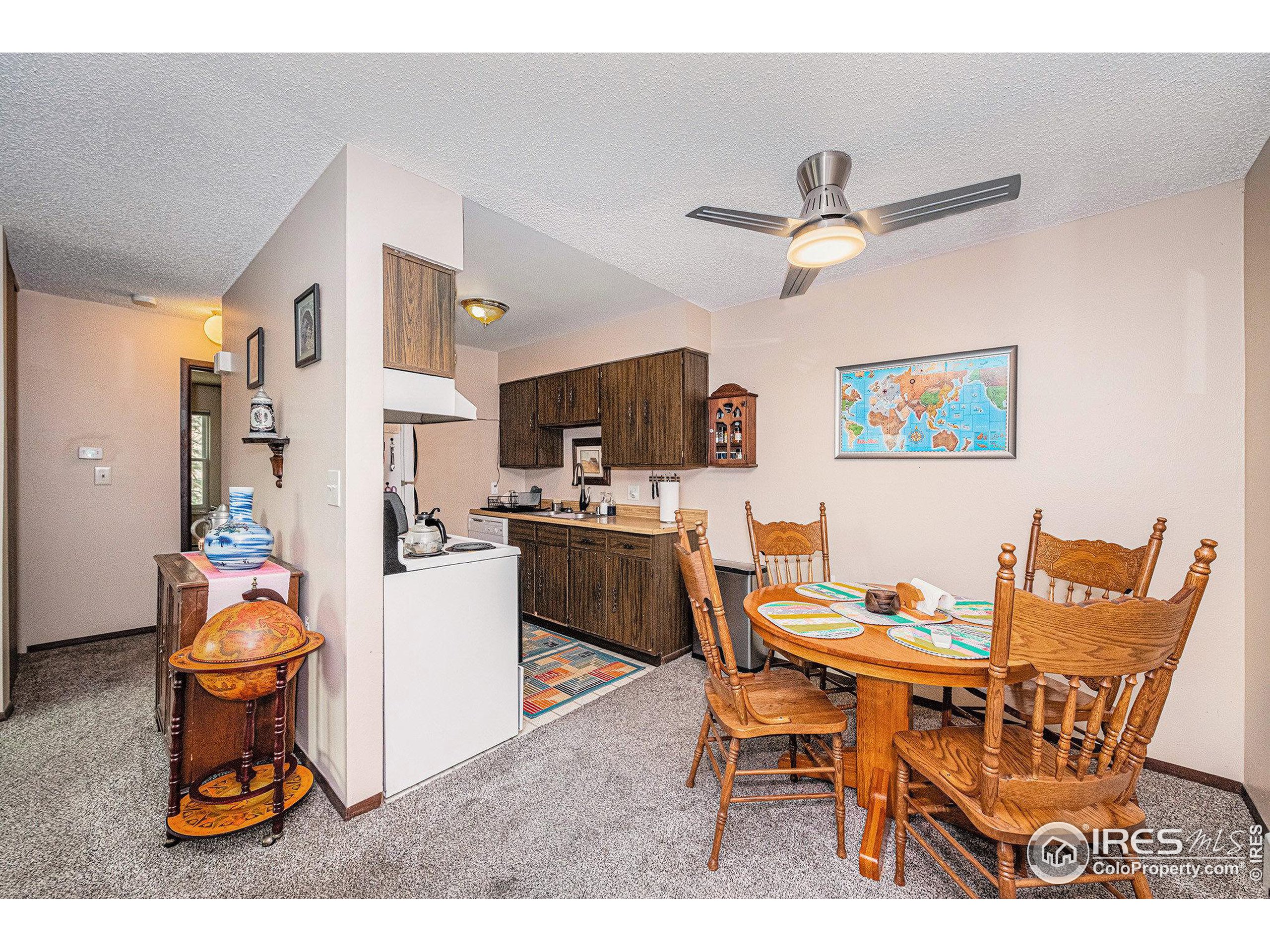 3400 Stanford Road, Unit A120 Fort Collins, CO 80525 - Photo 7 of 16 a dining room with a table and chairs