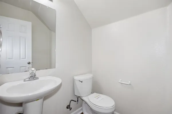 a bathroom with a sink a toilet and mirror