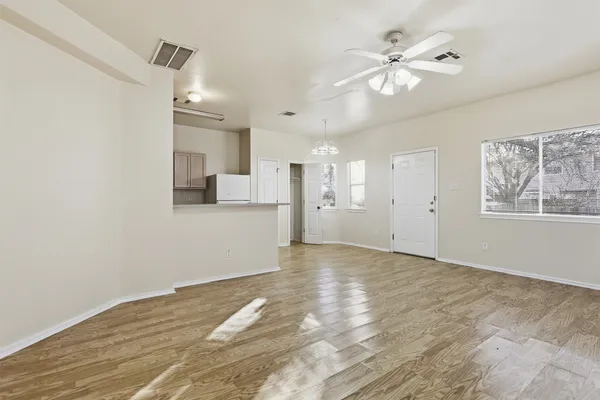 a view of a kitchen with a sink and a refrigerator