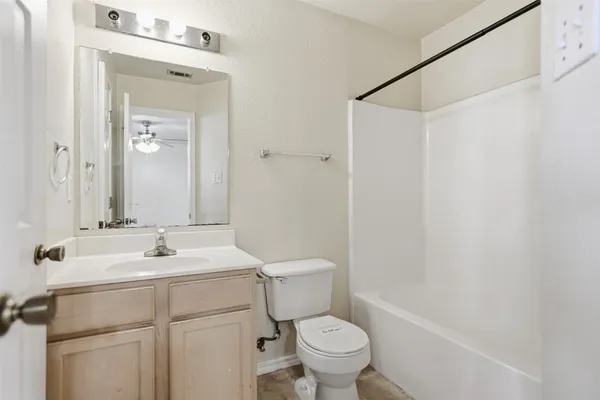 a bathroom with a sink toilet vanity and shower