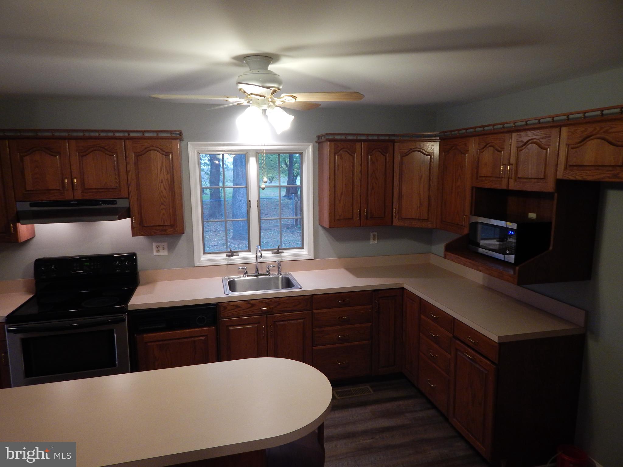 5525 Summit Point Road Charles Town, WV 25414 - Photo 12 of 41 KITCHEN HAS AN ISLAND FOR WORKSPACE AND STORAGE
