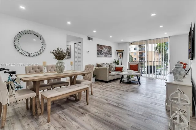 a living room with furniture a rug and a large window