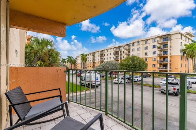 a balcony with table and chairs