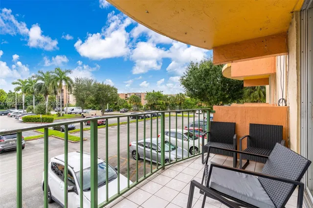 an aerial view of a city with lots of residential buildings ocean and mountain view in back