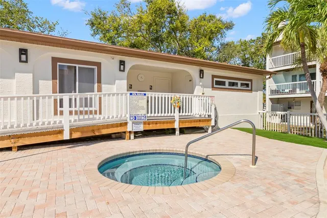 a backyard of a house with swimming pool and furniture