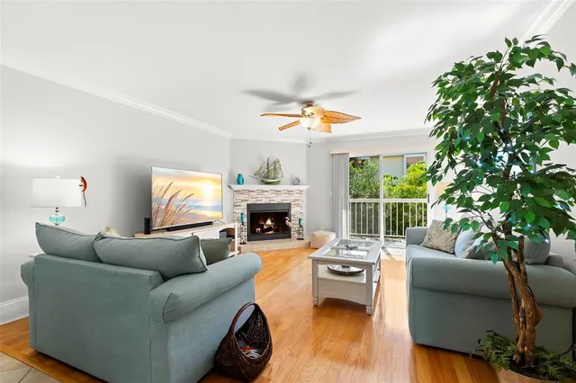 a living room with furniture a fireplace and a potted plant
