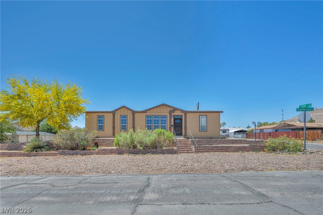 225 California Street Searchlight, NV 89046 - Photo 2 of 64 A well-maintained facade with brick retaining walls welcomes you to this desert home.