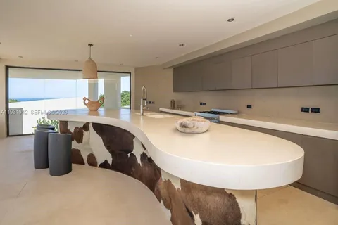 a room with pool table and windows