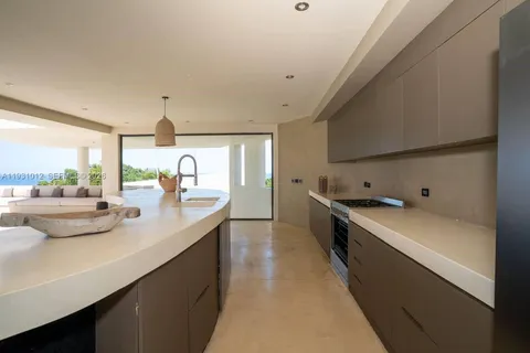 a living room with large windows and a couch