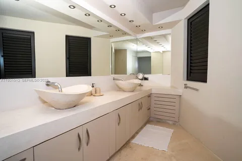 a bathroom with a double vanity sink and mirror