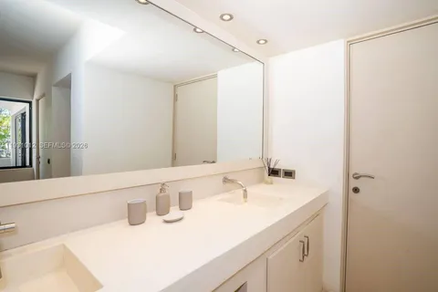 a bedroom with a large bed and a large window