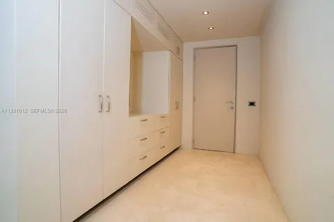 a living room with a bed furniture and a large window